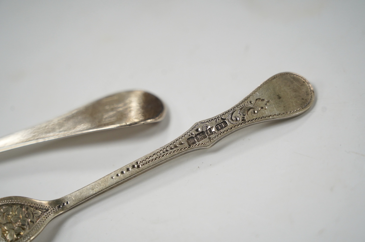 An early 18th century Hanovarian rat-tail pattern table spoon, indistinct marks, 19.6cm and a small quantity of later assorted silver flatware, 21.7oz. Condition - poor to fair
